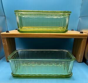Uranium depression glass refrigerator dishes from the 30’s glows green. One lid.